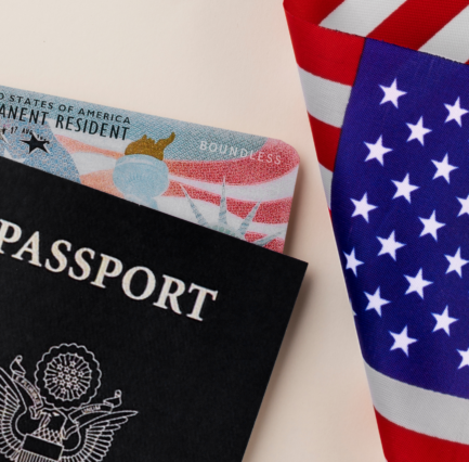 5 A US passport and Permanent Resident green card resting on the American flag