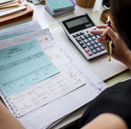 Asian woman working through paperwork Asian woman working through paperwork