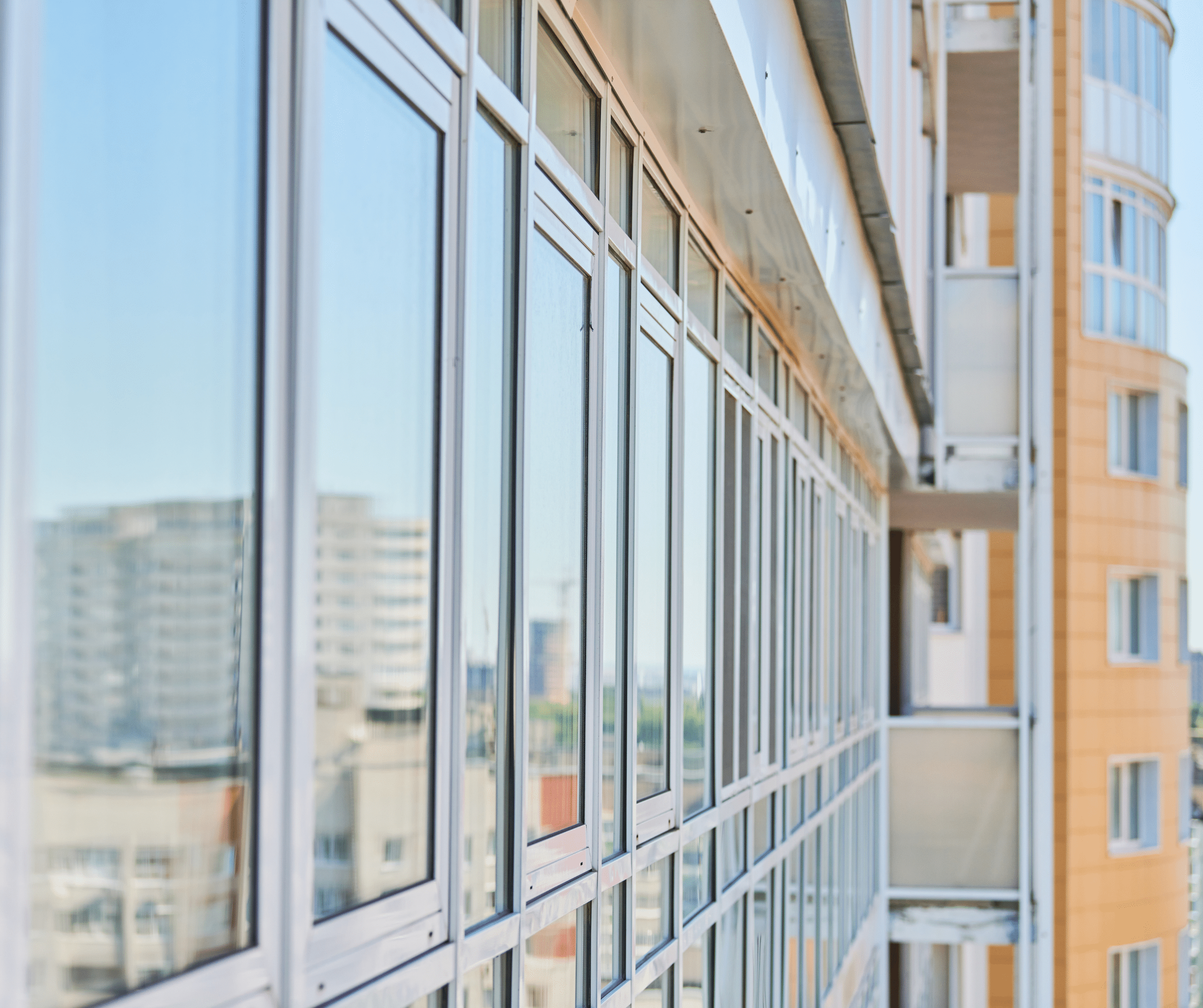Close-up of a modern glass office building facade with large windows