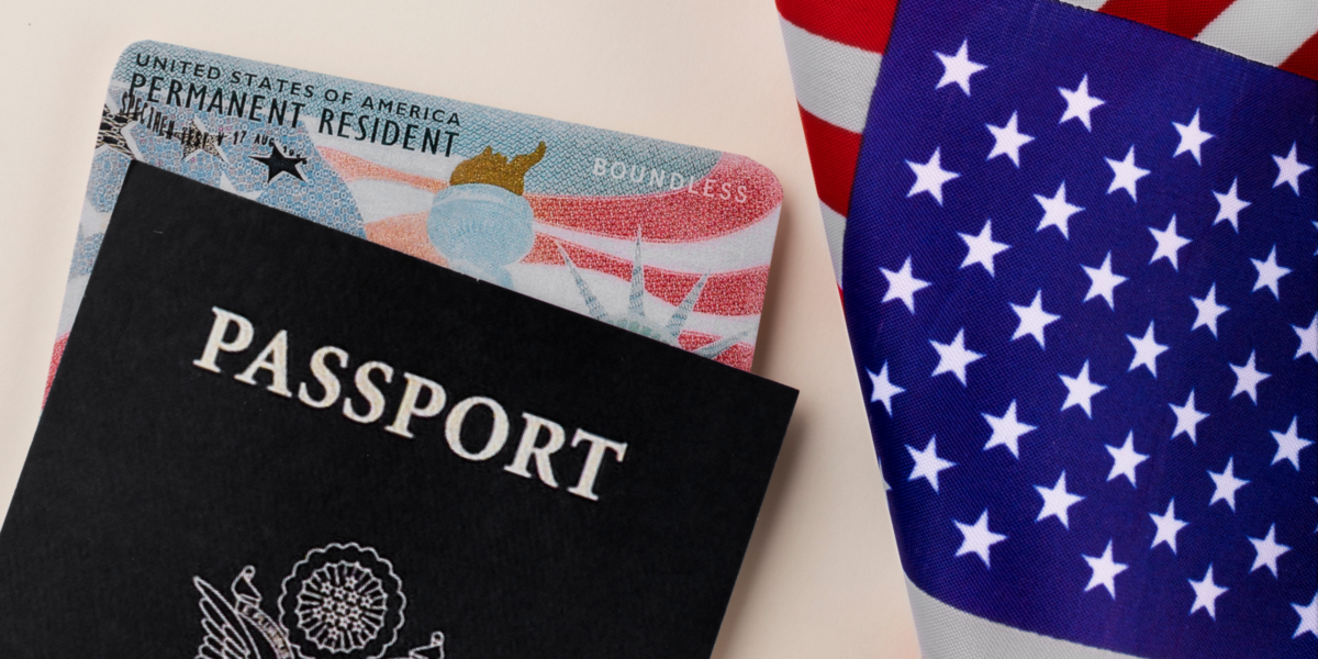5 A US passport and Permanent Resident green card resting on the American flag