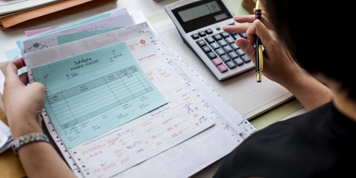 Asian woman working through paperwork Asian woman working through paperwork